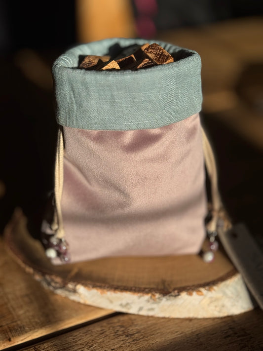 Handmade blush pink velvet rune bag with duck egg linen lining containing English oak handmade rune tiles